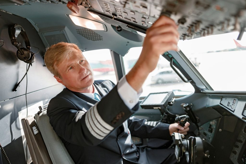 Aircraft pilot checking overhead panel before the flight