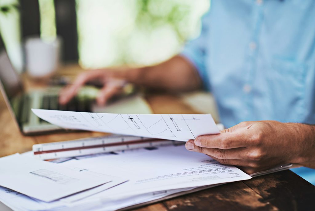 Taking a look at the paperwork. Cropped shot of a businessman reading some paperwork at home.
