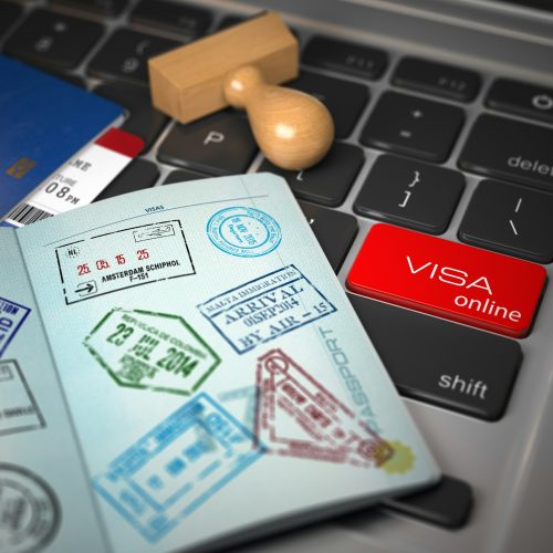 Visa online application concept. Open passport with visa stamps